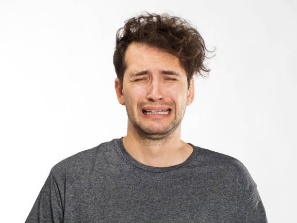 Frustrated and worried young man portrait in grey t-shirt Portrait of an angry young man crying stock pictures, royalty-free photos & images