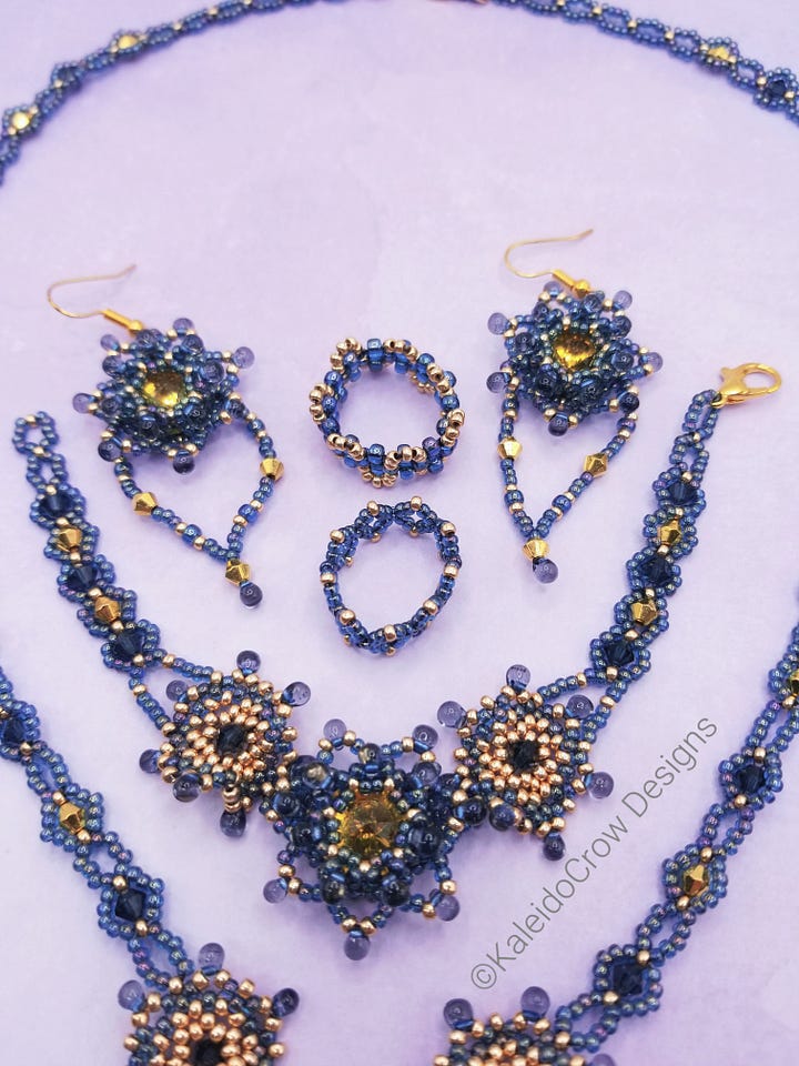 Photos of a beaded necklace, bracelet, earrings and rings in a gray blue color with gold color accents.