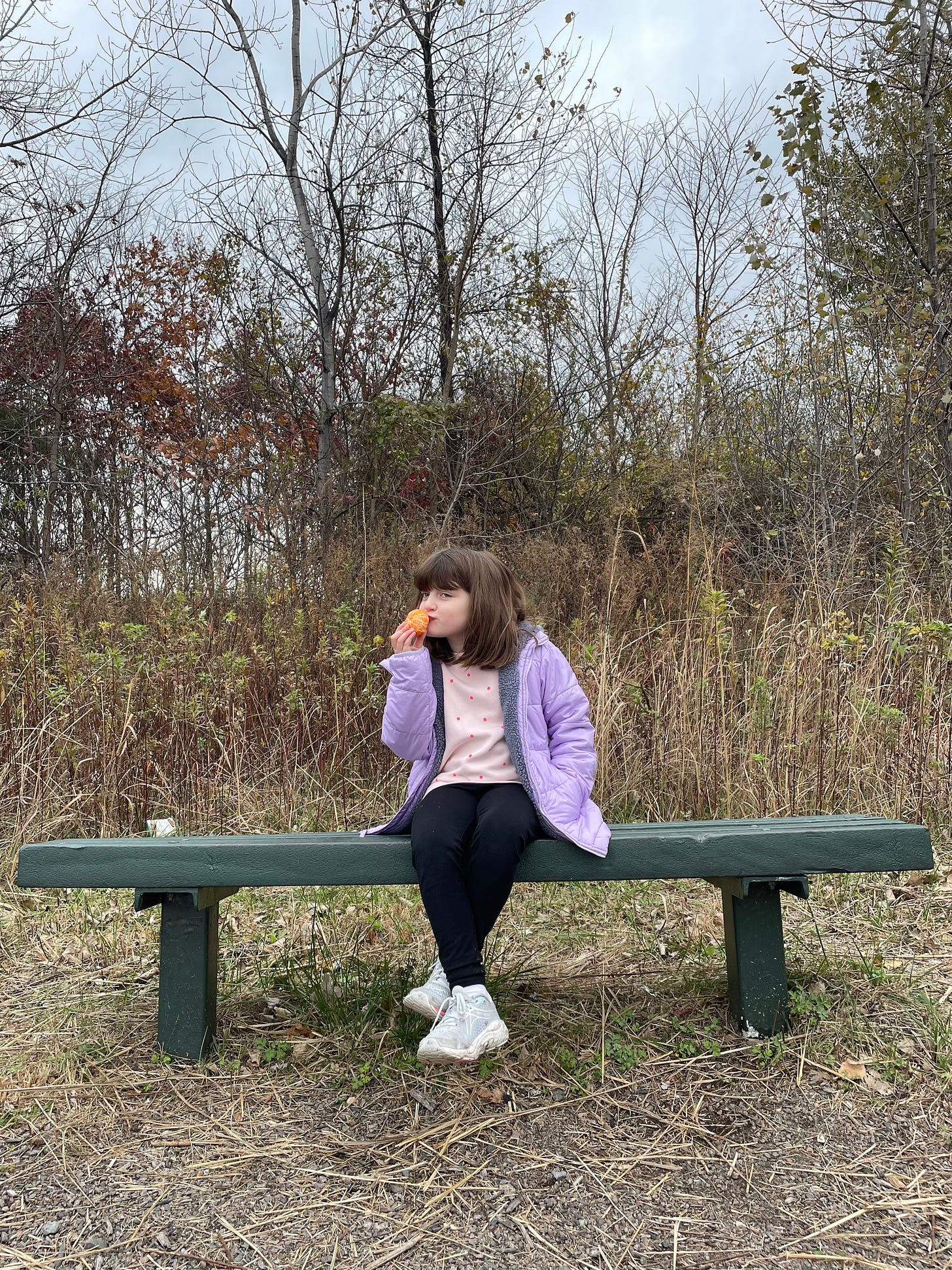 girl on bench with clementine
