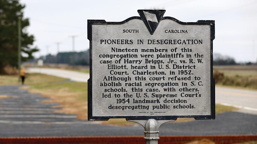 A historical marker that reads "Pioneers in Desegregation" outside Liberty Hill AME Church A historical marker that reads "Pioneers in Desegregation" outside Liberty Hill AME Church