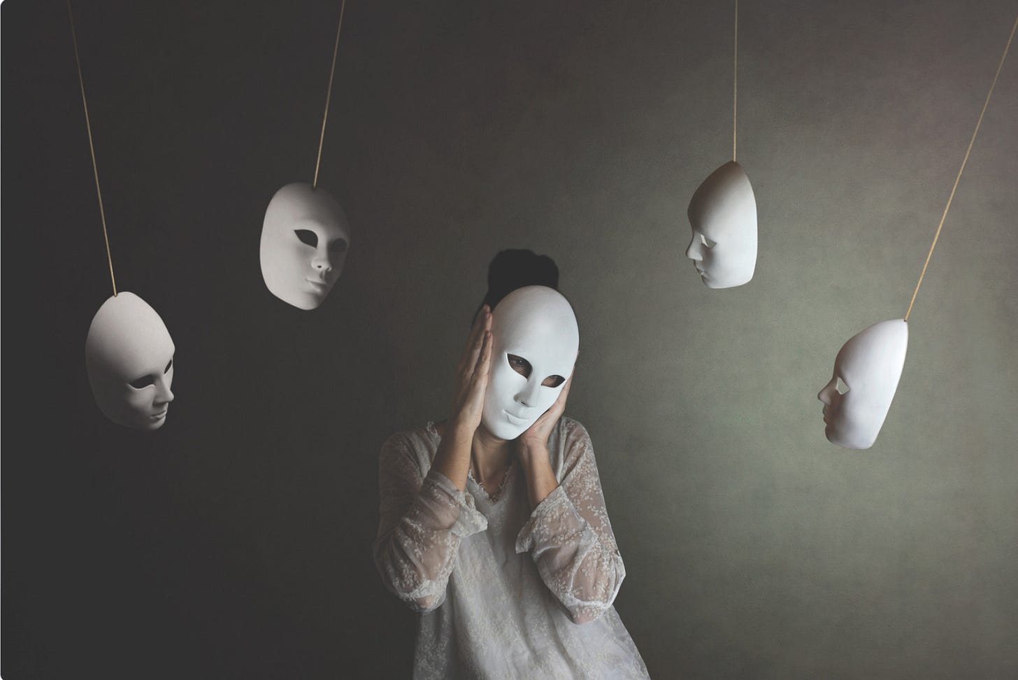 Woman wearing mask with mask swinging from ceiling
