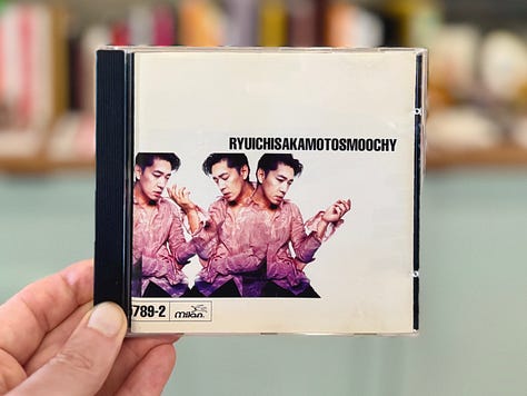 Photos of the Ryuichi Sakamoto "Smochy" compact disc, a Sony Discman D-2, and Sony CPA-7.