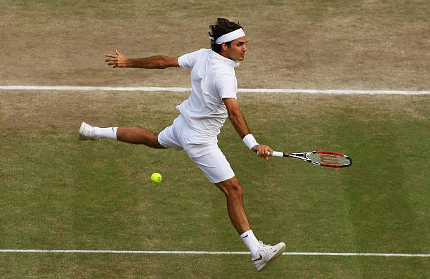 Roger Federer of Switzerland plays a backhand during the men's singles Final match against Rafael Nadal of Spain on day thirteen of the Wimbledon... Roger Federer of Switzerland plays a backhand during the men's singles Final match against Rafael Nadal of Spain on day thirteen of the Wimbledon...