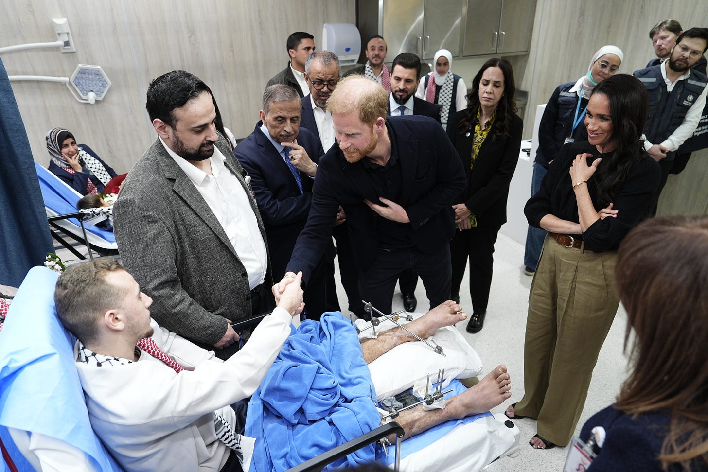 Prince Harry shaking the hand of a refugee in bed Prince Harry shaking the hand of a refugee in bed