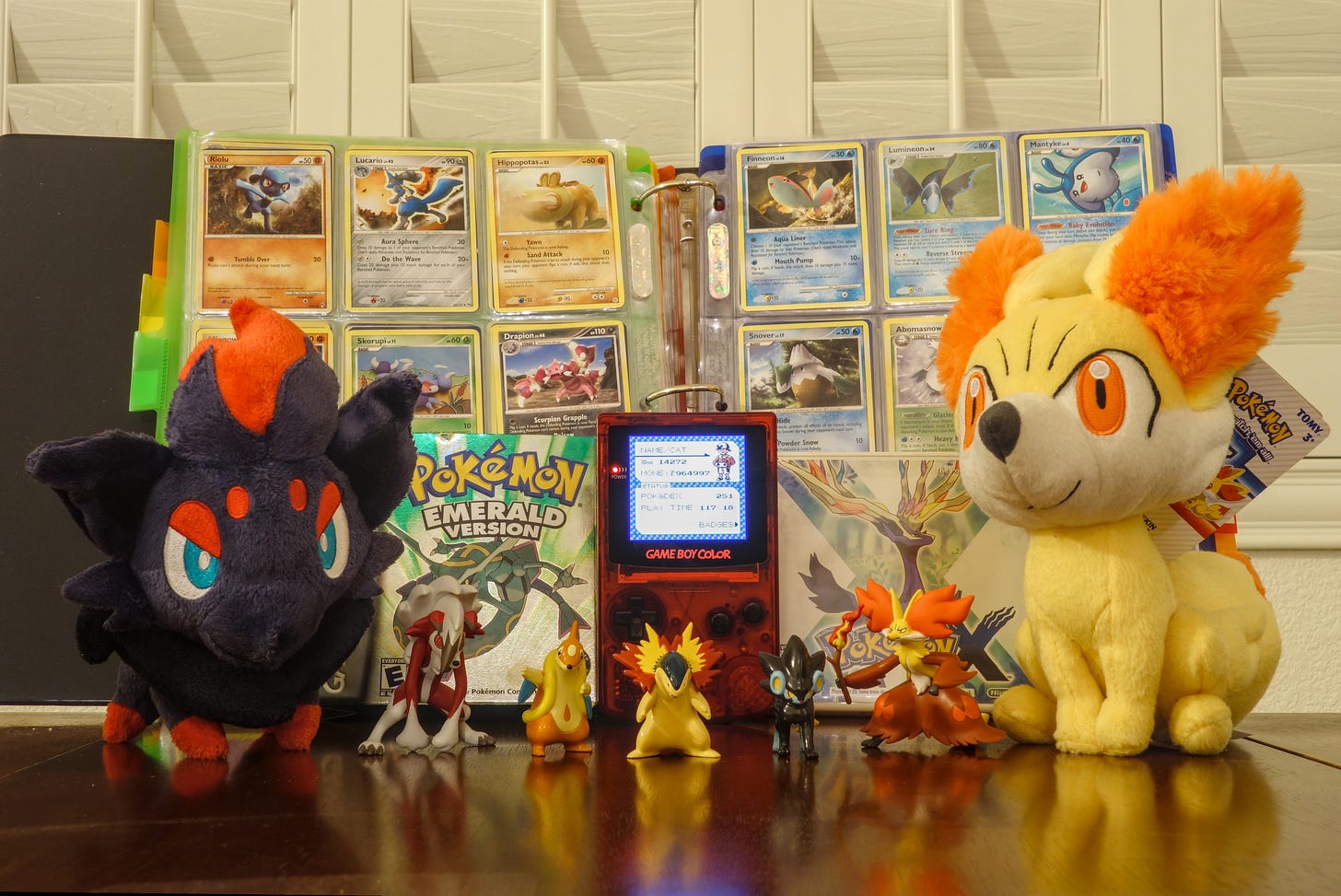 Cat's "CardDex" with plushies, games, and figures