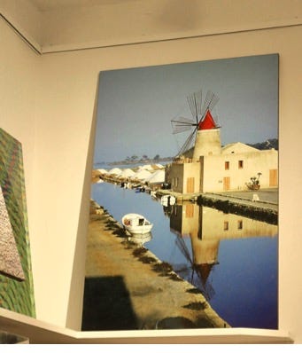 A painting of a windmill on a wall

Description automatically generated