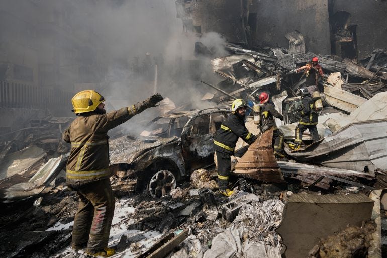 Firefighters and rescuers search for victims at the site of an Israeli airstrike in central Beirut, Lebanon, Wednesday, April 8, 2026. (AP Photo/Hussein Malla)