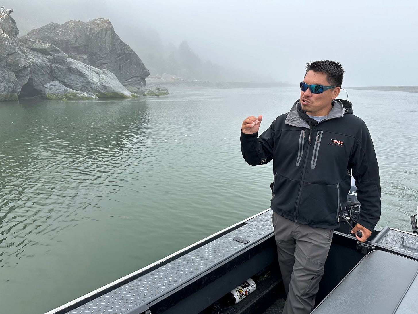 Pergish Carlson, a Yurok River guide, motoring on the Klamath River near the Pacific Ocean at the river's mouth in late July. 