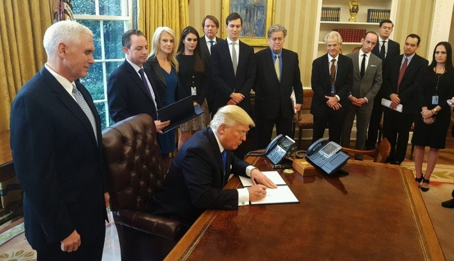 President Donald Trump signing executive orders in the Oval Office on Jan. 24. Trump's revised executive order barring entry from several Muslim countries will go into effect March 16.