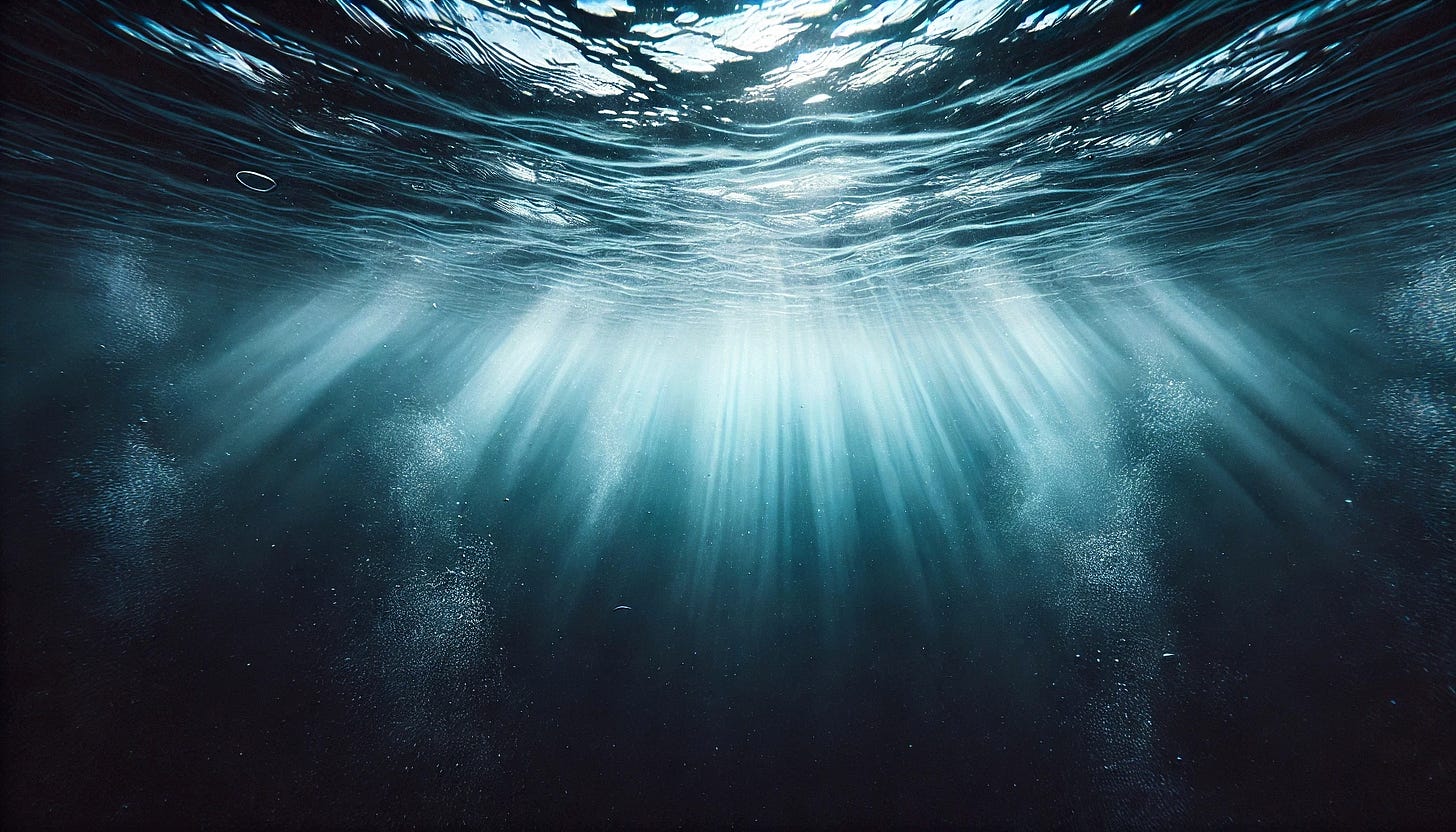 View from beneath the ocean surface looking upward toward diffuse light rays filtering through dark water, fading into darkness below. View from beneath the ocean surface looking upward toward diffuse light rays filtering through dark water, fading into darkness below.