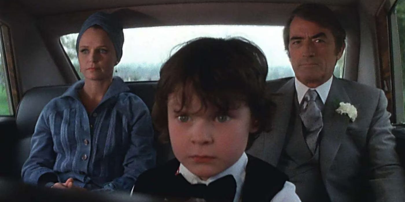 The Antichrist Damien sits between Gregory Peck and Lee Remick in a car in the 1976 The Omen. The Antichrist Damien sits between Gregory Peck and Lee Remick in a car in the 1976 The Omen.