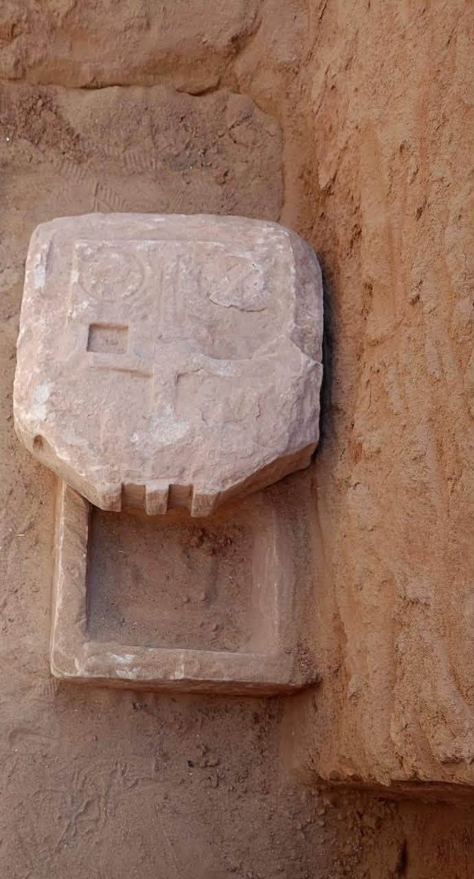 A sandstone offering table set above its purification basin, from a newly uncovered Roman-period pyramid tomb at Bir el-Shaghala, Dakhla Oasis, Egypt.