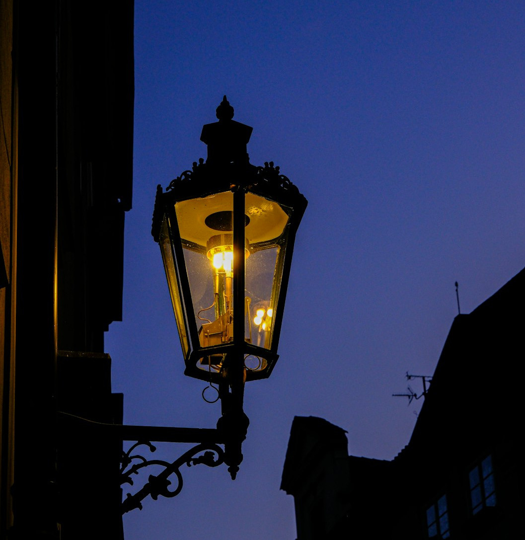 a street light with a building in the background