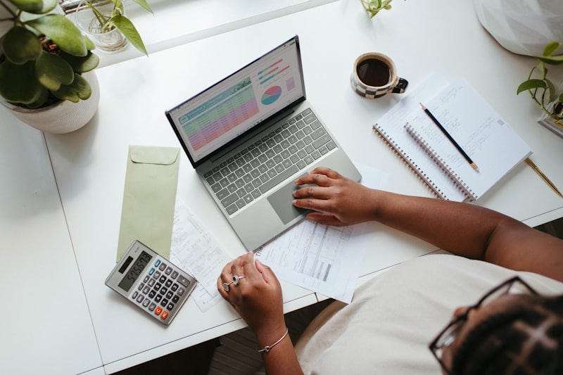 A professional reviewing business growth charts and SEO optimization data on their computer A professional reviewing business growth charts and SEO optimization data on their computer