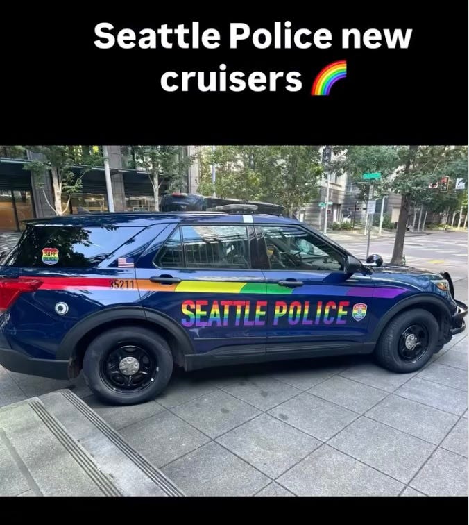 Image: A Seattle police car adorned in LGBTQ pride colors