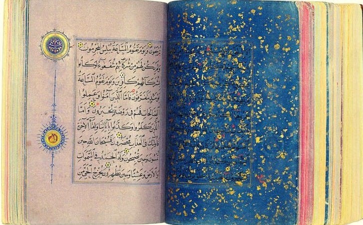 This may contain: an open book with arabic writing on the pages and gold confetti sprinkles