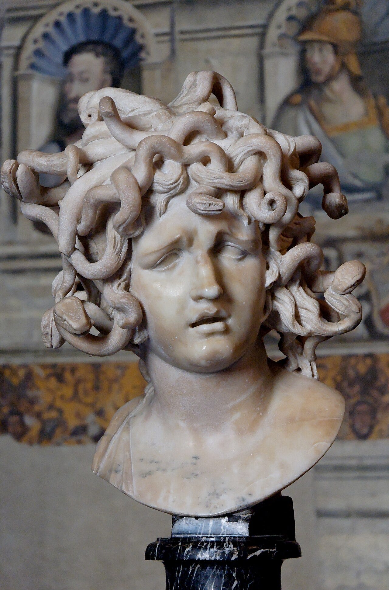 Marble bust of Medusa turning to stone Marble bust of Medusa turning to stone