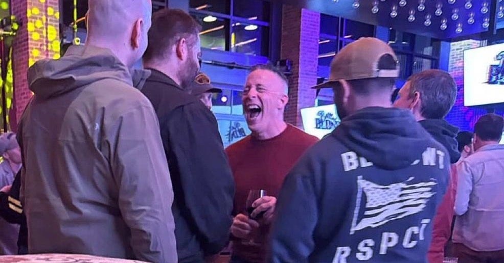 May be an image of one or more people, crowd and text