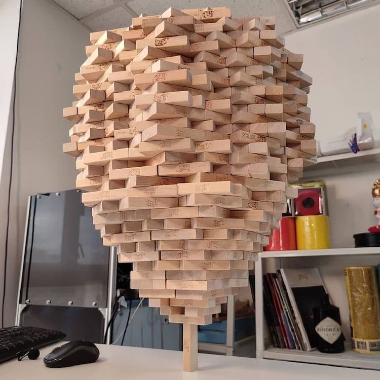 Guy Breaks His Own World Record for Balancing 1,512 Jenga on One