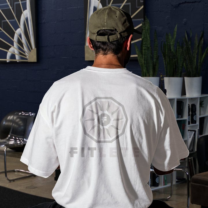 The toned fitlete logo sits on top of a shirt with its same color at a different shade or tone.