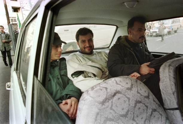 Iranian cartoonist Nik Ahangh-Kosar is taken to Tehran's Evin prison 5 February 2000 after being questioned over two cartoons in the pro-reform Azad... Iranian cartoonist Nik Ahangh-Kosar is taken to Tehran's Evin prison 5 February 2000 after being questioned over two cartoons in the pro-reform Azad...