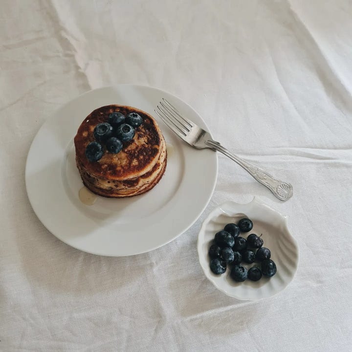 Banana and sourdough pancakes with blueberries and honey