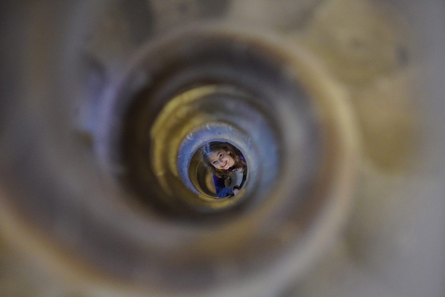 A young child is photographed down the tower’s snail-spiraled staircase on the descent of the Nativity tower