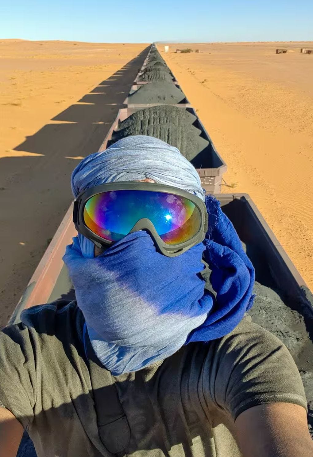 Adventure traveler riding the Mauritania Train across the Sahara Desert. Adventure traveler riding the Mauritania Train across the Sahara Desert.