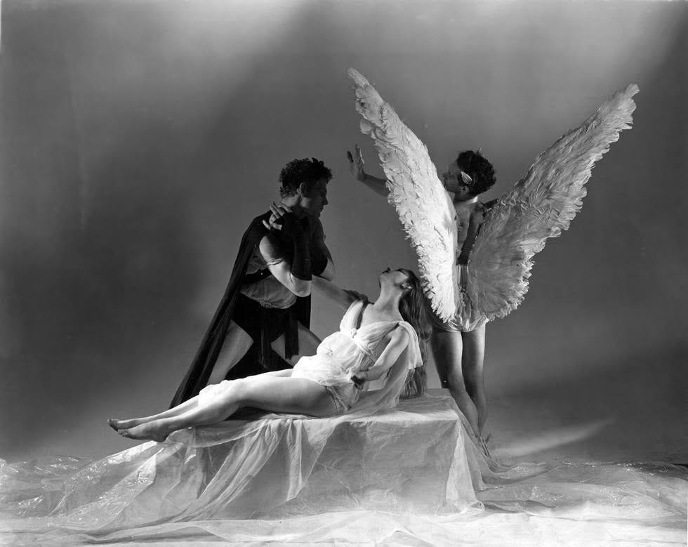 Black and white image of three mythological characters: Orpheus, a man leaning over his wife, Eurydice, while a third figure, the god Apollo, stands in the back of the scene, his back turned to us and his large white wings spread
