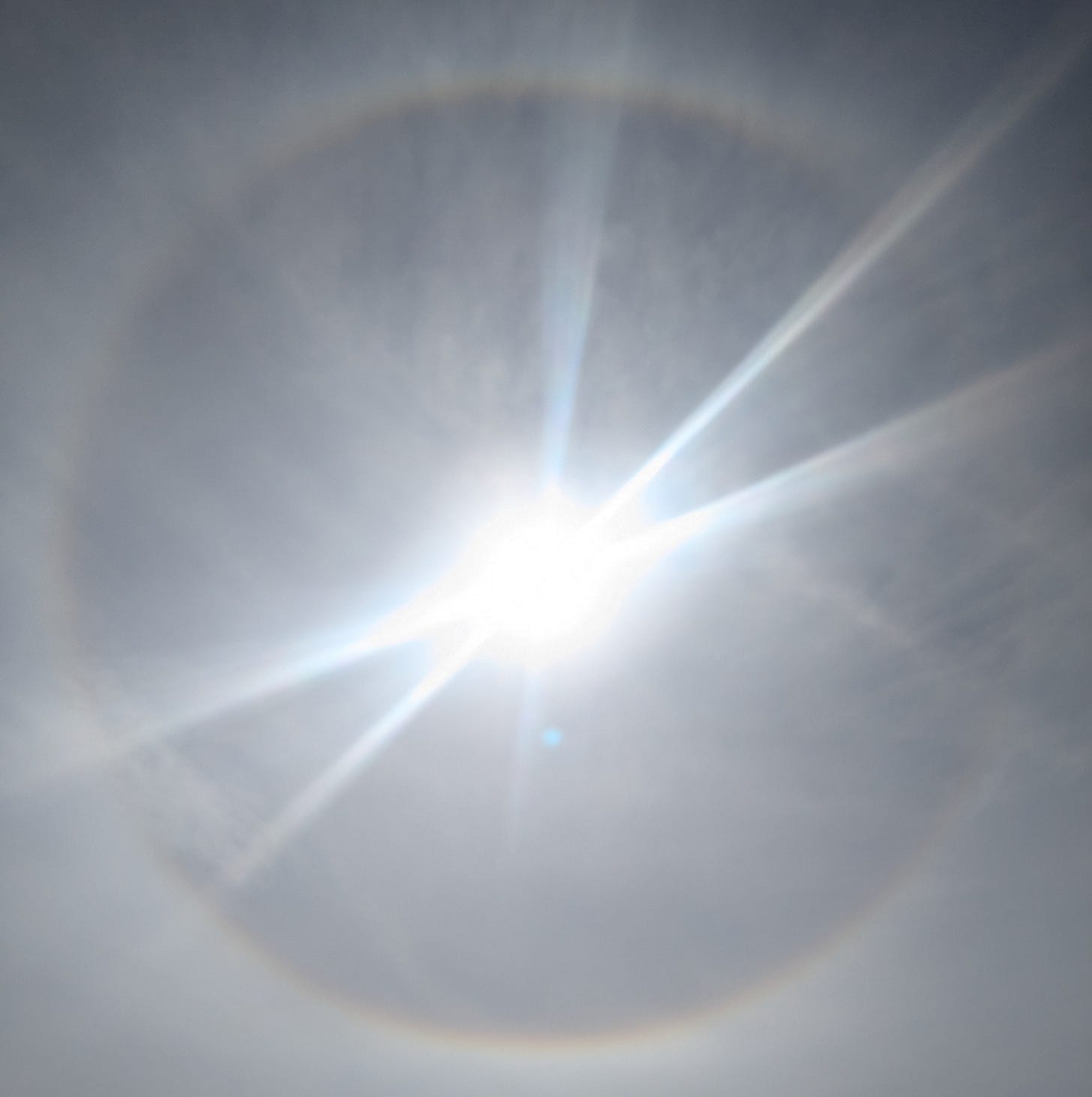 Photo of a rainbow ring around the sun. Photo of a rainbow ring around the sun.