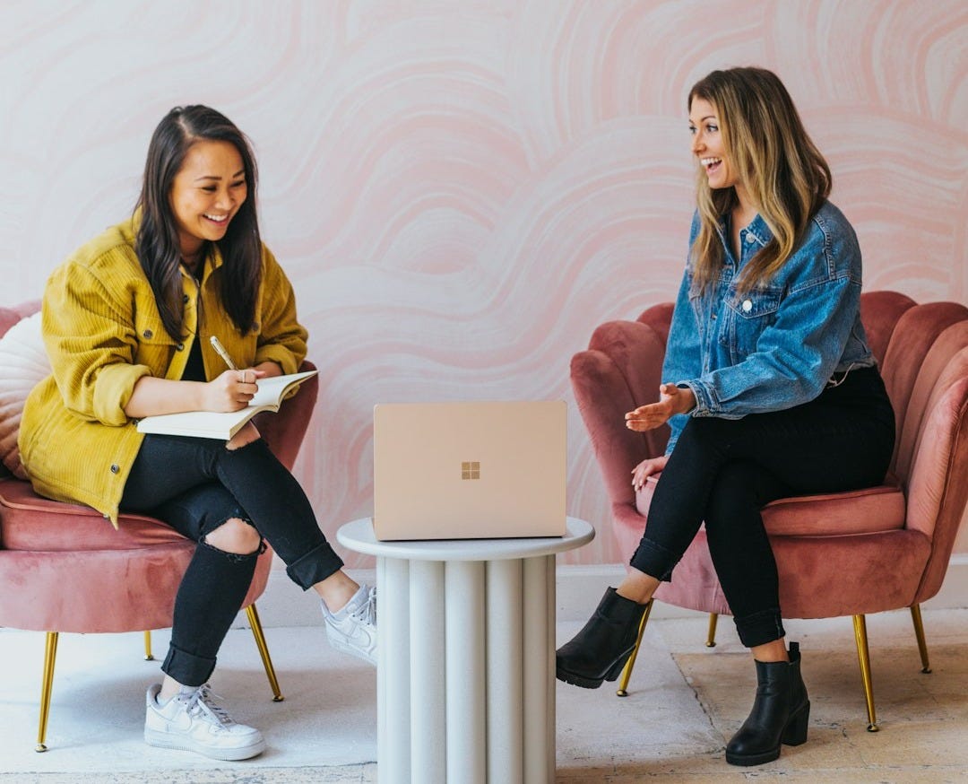 3 women sitting on chair