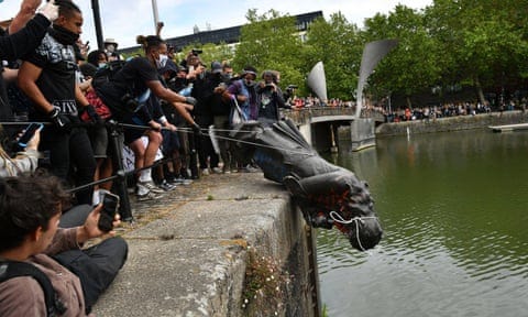 Protesters throwing the statue of Edward Colston into Bristol harbour during a Black Lives Matter protest rally.
