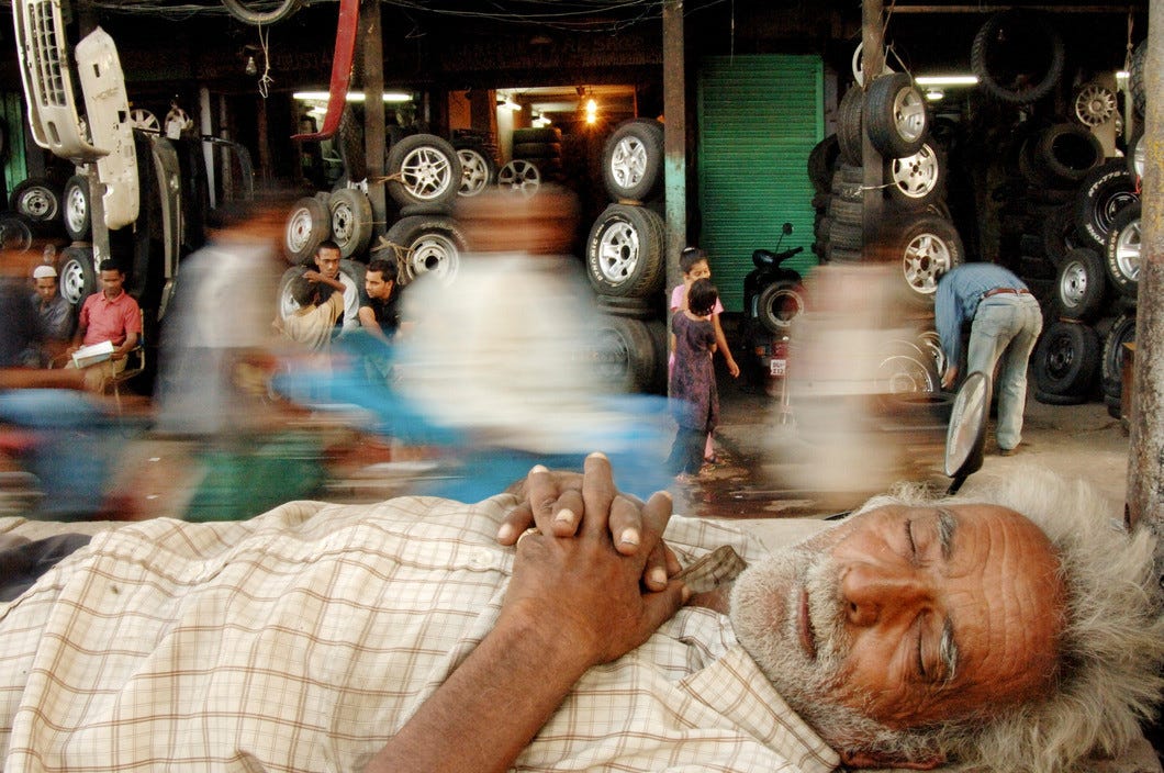A rickshaw driver taking a nap, Jama Masjid, Delhi, India, 2005. © Raghu Rai / Magnum Photos