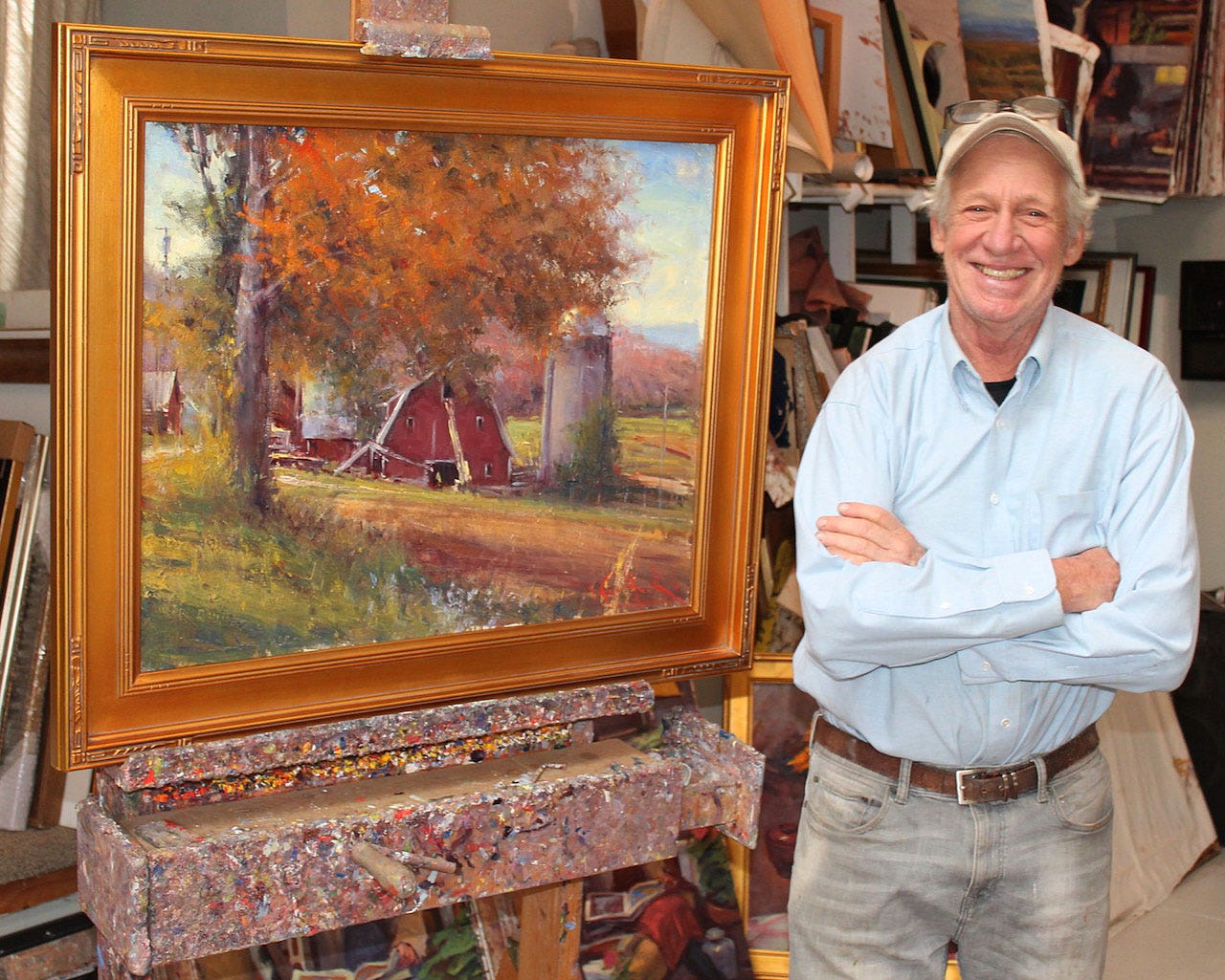 A person standing next to a painting

Description automatically generated
