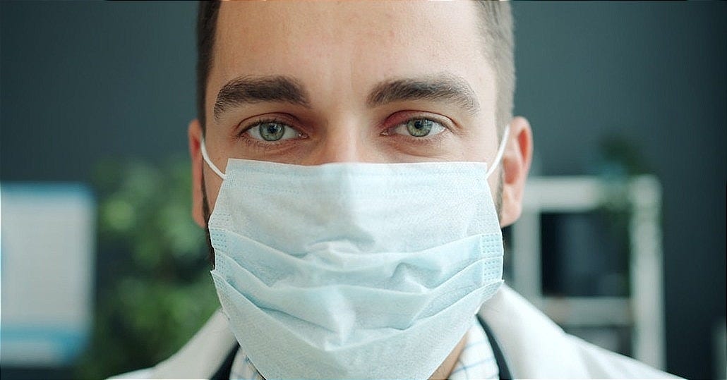 Doctor wearing a protective face mask in medical office