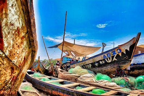 Canoes, boys, girls, pier at James in Accra, Ghana