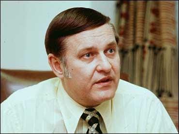 A person in a white shirt and tie

Description automatically generated