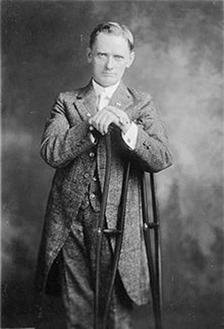 A person in a suit holding a crutch

AI-generated content may be incorrect.