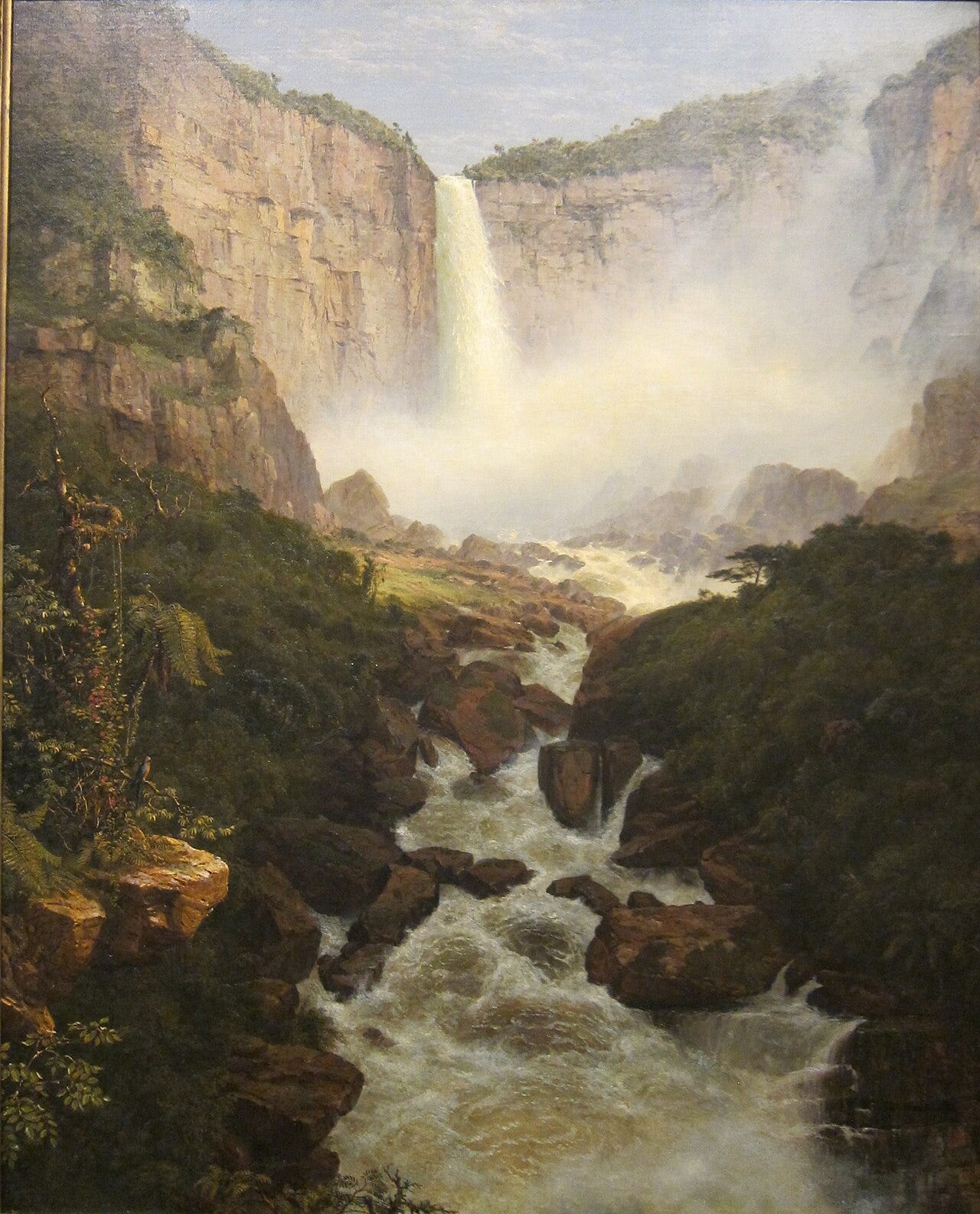 A tropical waterfall plunges into a deep green gorge in the South American mountains A tropical waterfall plunges into a deep green gorge in the South American mountains