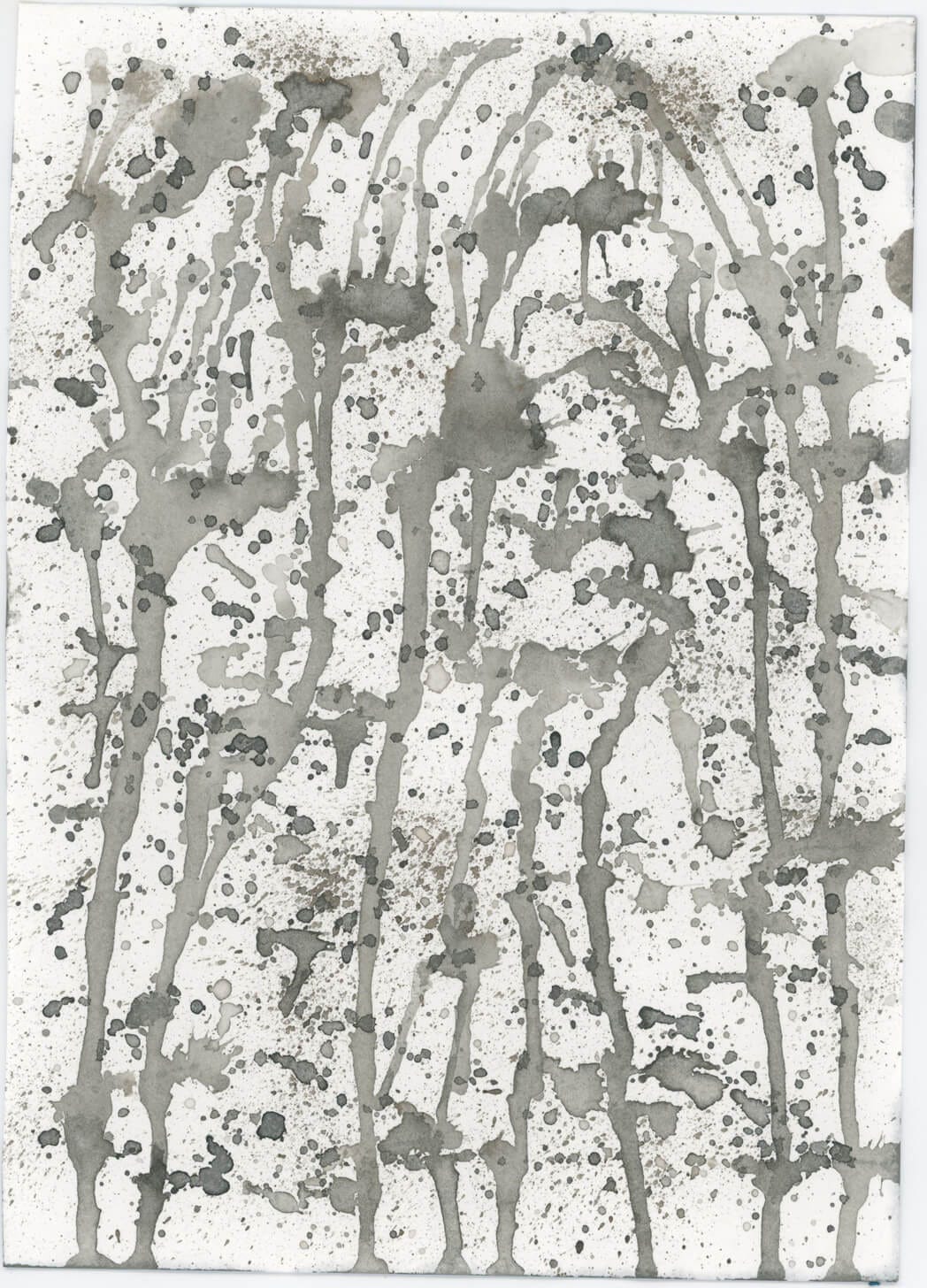Grey and black ink splatters and runs on a piece of paper, to create rain like effect. by Nanette Regan