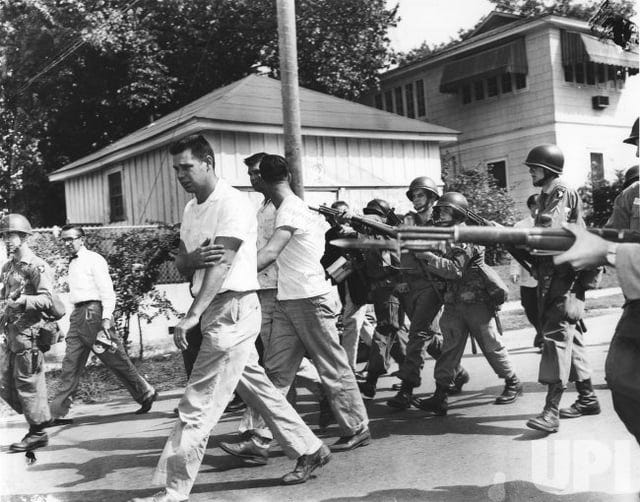 r/MilitaryPorn - a group of people marching with guns