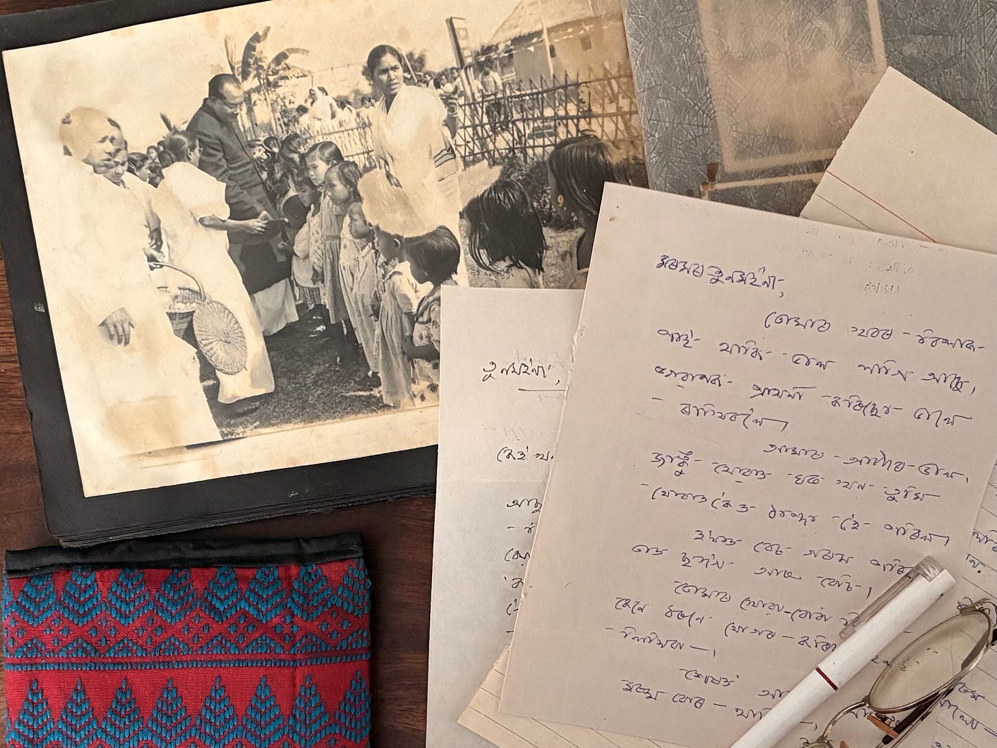 A cherished letter from the author’s late mother, written in Assamese, surrounded by personal mementos that hold sentimental value. A cherished letter from the author’s late mother, written in Assamese, surrounded by personal mementos that hold sentimental value.