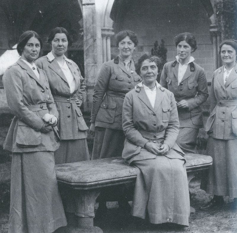 A black and white photograph from WWI with 6 Scottish ladies working in Roaumont's hospital, one is sitting on a bench, the others standing behind her: Frances Ivens (seated) and (standing, left to right) Dr. Agnes Savill, Ruth Nicholson, Dr. Jessie Augusta Berry, Dr. Winnifred Margaret Ross, and Dr M.D. Hancock. A black and white photograph from WWI with 6 Scottish ladies working in Roaumont's hospital, one is sitting on a bench, the others standing behind her: Frances Ivens (seated) and (standing, left to right) Dr. Agnes Savill, Ruth Nicholson, Dr. Jessie Augusta Berry, Dr. Winnifred Margaret Ross, and Dr M.D. Hancock.