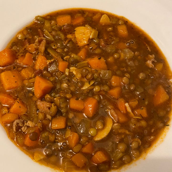 2 different bowls of soup - one with carrots & lentils, the other with chicken, noodles and vegetables