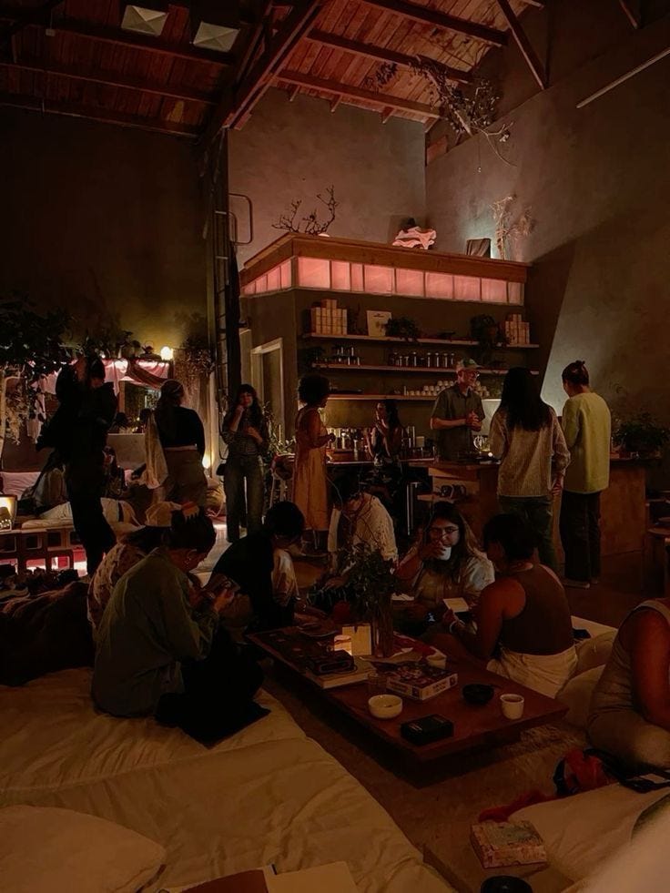 This may contain: a group of people sitting around a table in a room