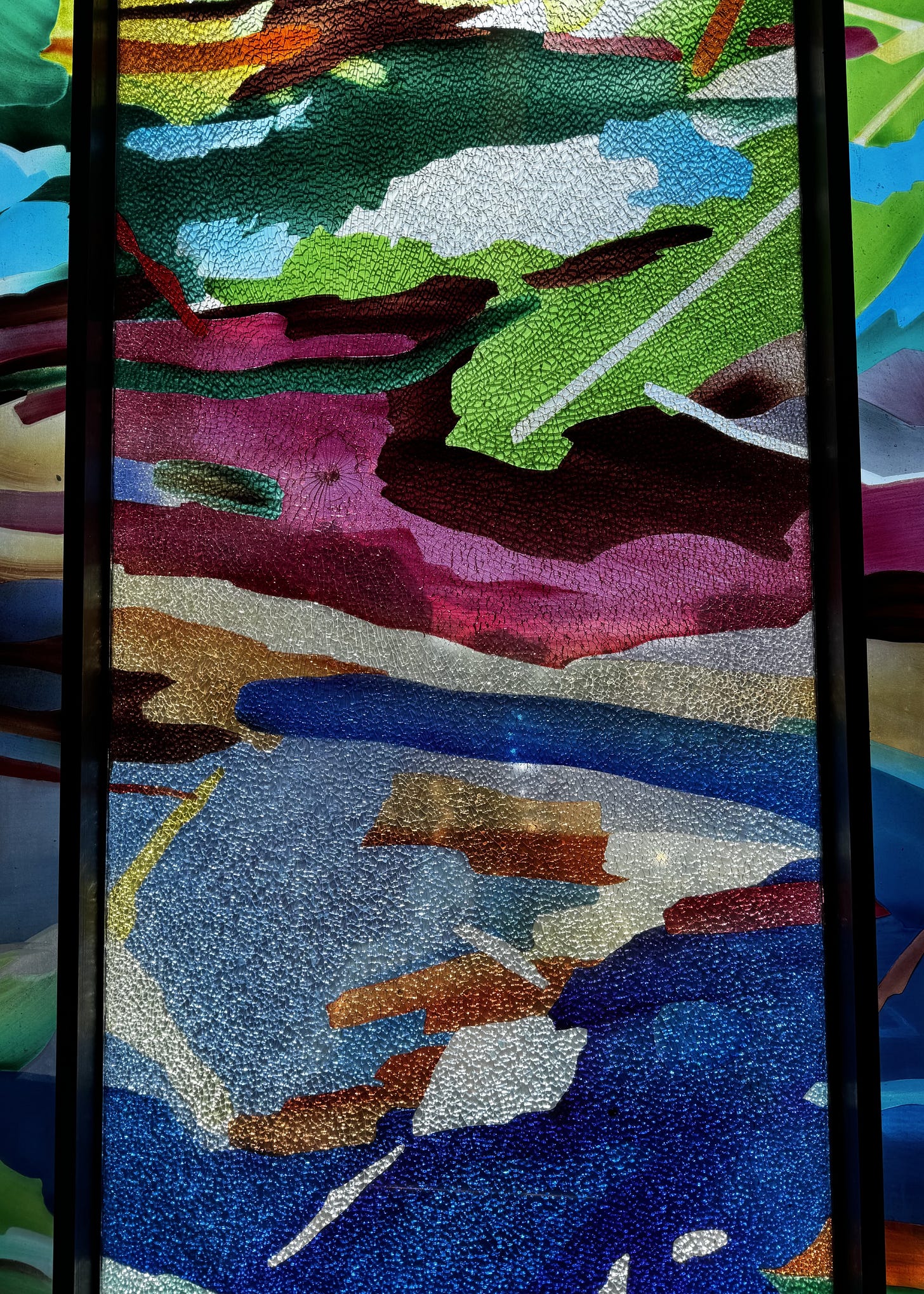 abstract mural on glass in three panels, with the middle panel being cracked in thousands of pieces but still holding together