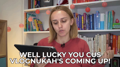 Hannah saying, "Well, lucky you, cus Vlognukah's coming up!"