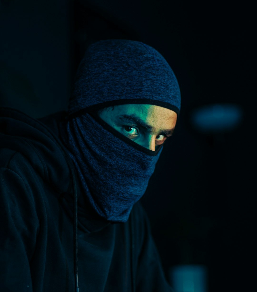 a man wearing a black hoodie and a blue mask a man wearing a black hoodie and a blue mask