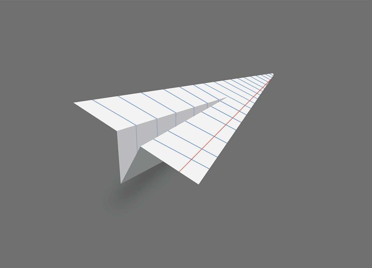 Grey background with paper plane folded from ruled white paper