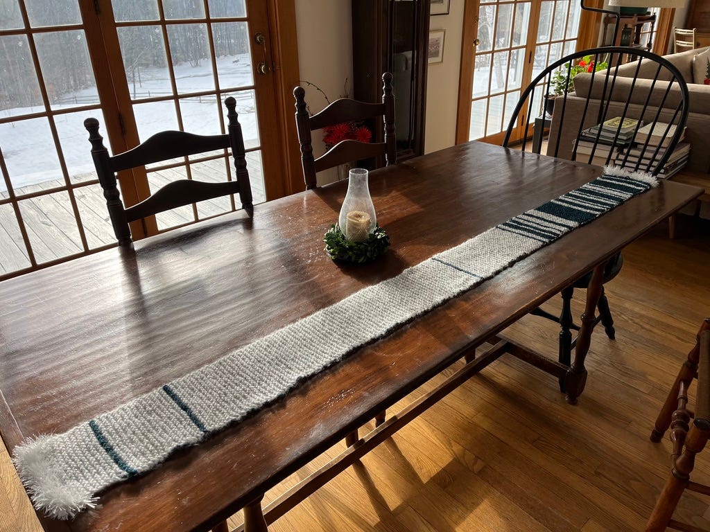 A blue and white striped scarf on a table